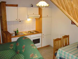 a kitchen with a table and a kitchen with a stove at Pension Martens - Gaubenwohnung in Wieck