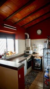 a kitchen with a sink and a stove top oven at Casa Indiano 