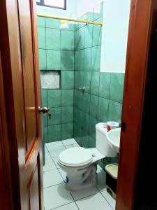 a bathroom with a toilet and a sink at EMMA HOUSE in Puerto Baquerizo Moreno