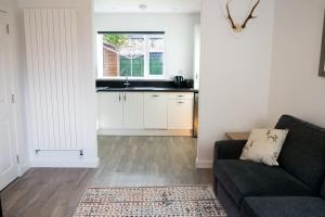 a living room with a couch and a kitchen at Central 2 bedroom luxury home close to River Ness in Inverness +13 photos