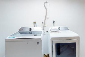a washing machine sitting on top of a counter at Peace Among the Pines in Wellfleet +23 photos
