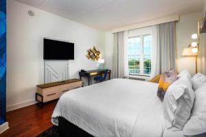 a hotel room with a bed and a flat screen tv at Hotel Indigo Jacksonville-Deerwood Park, an IHG Hotel in Jacksonville