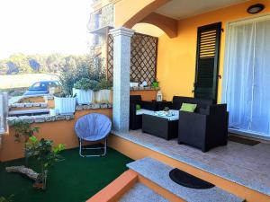 a patio with a table and chairs on a balcony at Apartment M&J - Valledoria - LA Muddizza - Free WI-FI in Valledoria