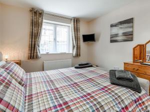 a bedroom with a bed and a television in it at Cozy Lodge in Barton-upon-Humber