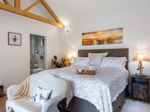 a bedroom with a large bed with a basket on it at North Farm Lodge in East Mersea