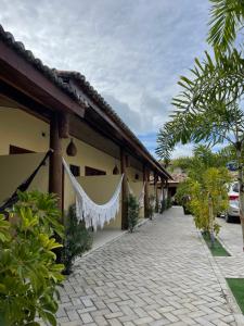 a building with a white curtain hanging from it at Pousada Lua Nova Charmosa Pipa in Pipa