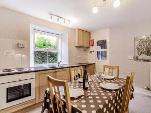 a kitchen with a table with a polka dot table cloth at High Rake in Glenridding