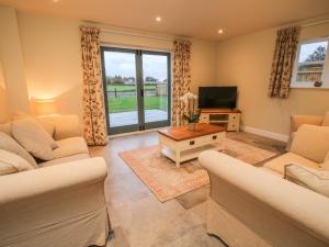 a living room with two couches and a television at The Barn in Shrewsbury