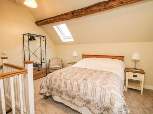 a bedroom with a bed and a skylight at Cow'ouse in Shrewsbury