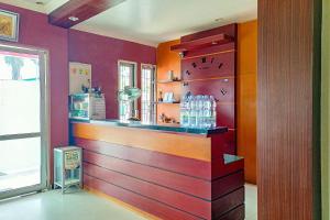a bar in a room with a colorful wall at OYO 91936 Hotel Lima Dara in Tanjungselor
