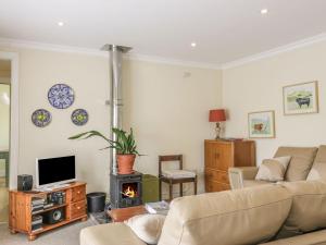 a living room with a couch and a fireplace at Lantonhall West Wing in Lanton