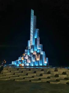 a tall building is lit up at night at Hostel Ngọc Liên in Tuy Hoa