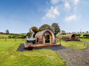 a luxury yurt in a field with a house at Chestnut-uk36261 in Llanfair Caereinion