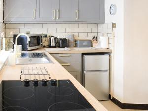 a kitchen with a sink and a counter top at Clematis Cottage in Penrith