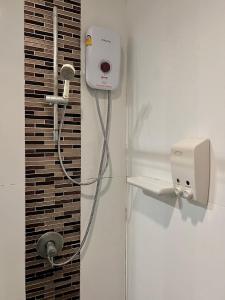 a bathroom with a shower with a hair dryer at Phi Phi Indigo Hotel in Phi Phi Islands