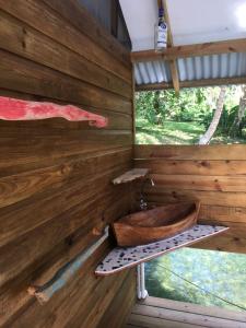 an inside view of a wooden cabin with a wooden sink at El Toucan Loco floating lodge in Tierra Oscura