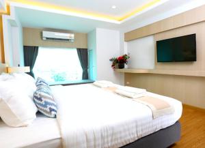 Postel nebo postele na pokoji v ubytování Sann Hotel