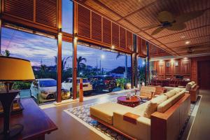 a living room with a couch and a large window at Sampatti Villas in Seminyak