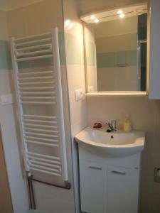 a bathroom with a sink and a mirror at Apartment U Pošty in Lipova Lazne