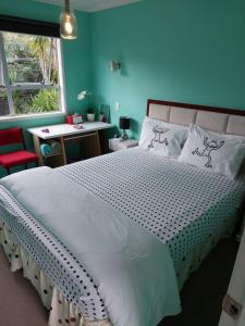 a bedroom with a large white bed with a window at Wendy's Holiday Home in Auckland