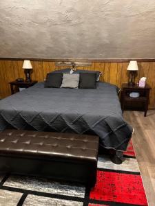 a bedroom with a bed with a leather couch at Cherry712upstairs in Fairborn