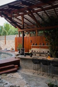 a patio with a table and chairs and a pool at Botånica Tulum in Tulum