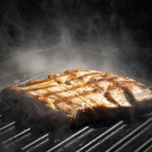 a piece of meat cooking on a grill at Terrace Green Hotel & Spa in Negombo