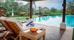 a villa with a swimming pool and a patio at Lotus Residence Tabanan in Tabanan +16 photos