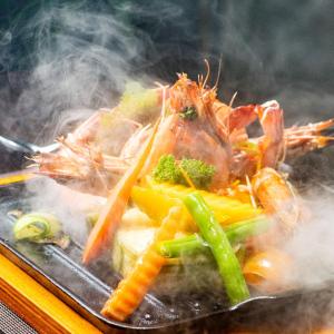 a plate of food with shrimp broccoli and other vegetables at Terrace Green Hotel & Spa in Negombo