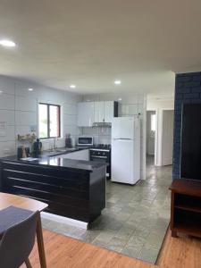 a kitchen with white cabinets and a white refrigerator at Jerilderie BNB - Pets Welcome - House in Jerilderie