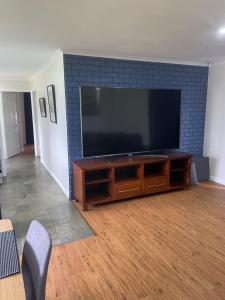 a living room with a large flat screen tv at Jerilderie BNB - Pets Welcome - House in Jerilderie