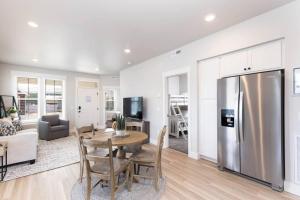 a kitchen and living room with a table and a refrigerator at Charming 3-bedroom in vibrant new neighborhood in Billings