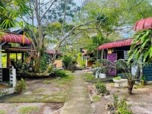 a house with a garden with a toilet in the yard at Blissful Cottage in Pantai Cenang