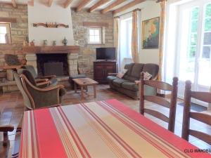 a living room with a couch and a fireplace at Maison Fouesnant, 5 pièces, 8 personnes - FR-1-481-47 in Fouesnant