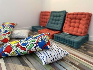 a group of pillows sitting on the floor in a room at Duplex à Combrit: plage à pied, piscine chauffée et tennis - FR-1-481-101 in Combrit +17 photos