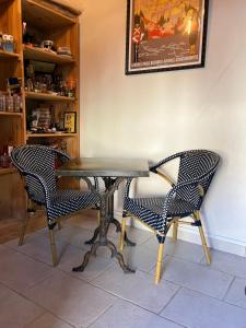 a table and two chairs in a room at Le Hameau du Buron - "La Taverne" - Option SPA in Eyzin-Pinet