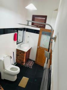 uma casa de banho com um WC e um lavatório em Poomaz Peace Palace em Ella