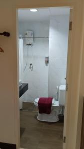 a bathroom with a shower and a toilet with a shower at Baan Wanchart in Bangkok
