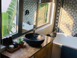 a bathroom with a bowl sink and a bath tub at Luxury 8br villa in An Bang beach Hoi An in An Bang