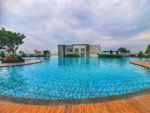 a large pool with blue water in front of a building at SKS Habitat Larkin Economy Business Unit in Johor Bahru