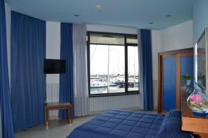 a hotel room with a bed and a television at Transatlantico in Naples