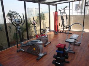 a gym with several exercise equipment in a building at Hotel Senses in Kolkata