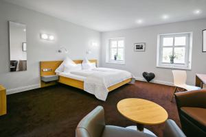 a hotel room with a bed and a table and chairs at Schloss Hotel Burgbrohl in Burgbrohl