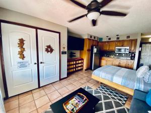 a kitchen with a bed and a ceiling fan at Da Kona West 305 in Kailua-Kona