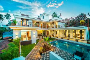 a house with a swimming pool in front of it at CanvaSand By Eease Hospitality in Nagaon