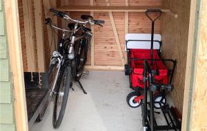 dos bicicletas estacionadas en un garaje con un carro rojo en Slow Down, en Büsum
