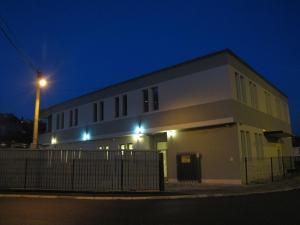a large white building with a street light at night at Motel Kobilj in Banja Luka