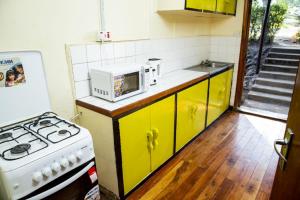 a kitchen with a stove and a microwave at Naro Moru River Lodge in Naro Moru
