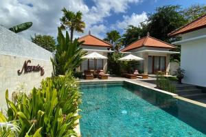 a swimming pool in front of a villa at Nau Nusa Villa in Nusa Penida