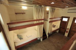 an overhead view of a room with three bunk beds at LaFinca Hostel Siargao in San Isidro